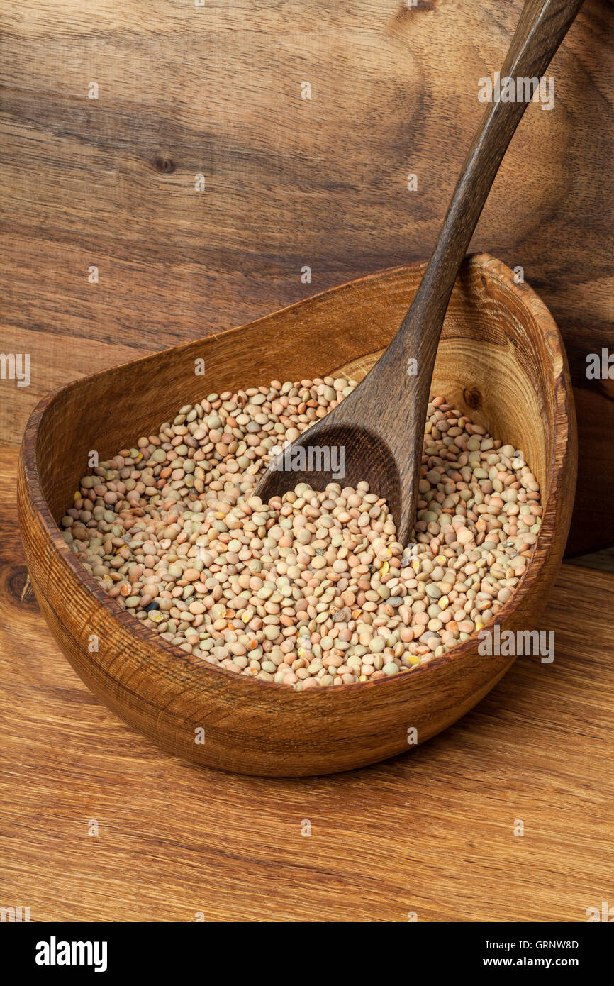 Image of lentils in a wooden bowl. Stock Photo