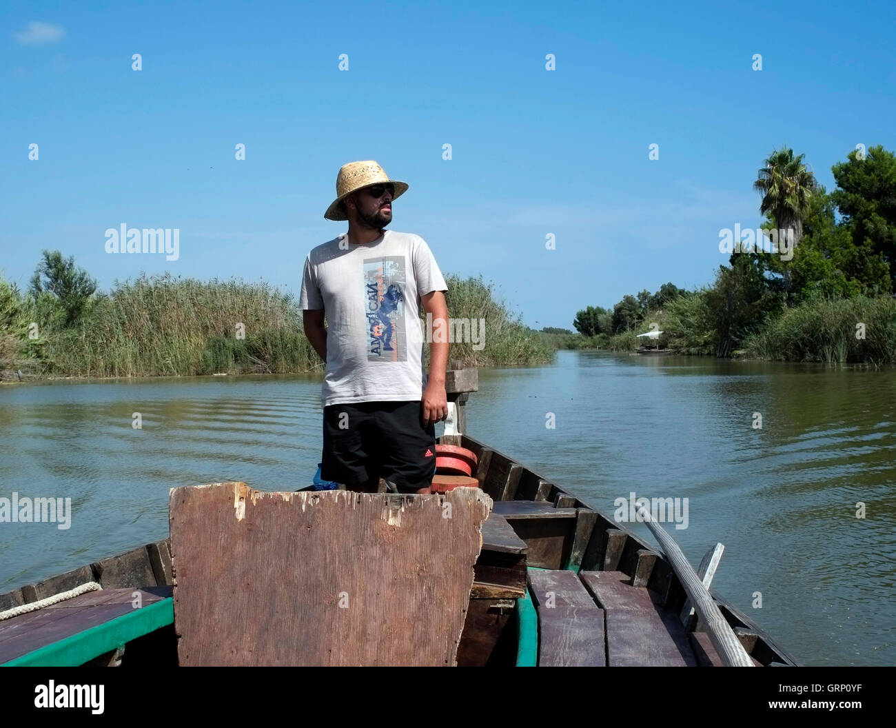 A boatman guides a boat on the Albufera Natural Park lake,  in Spain September 1, 2016. Copyright photograph John Voos Stock Photo