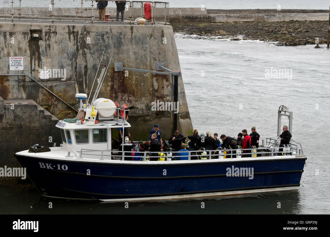 Boat carrying divers in Seahouses harbour in Northumberland, England. Stock Photo