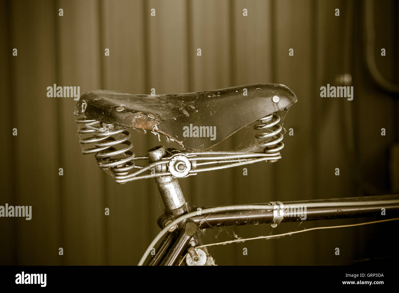A closeup of a saddle on an old vintage neglected bicycle. Stock Photo