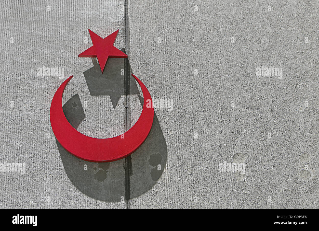 Turkish insignia on an exterior of a wall, with deep shadows. Stock Photo