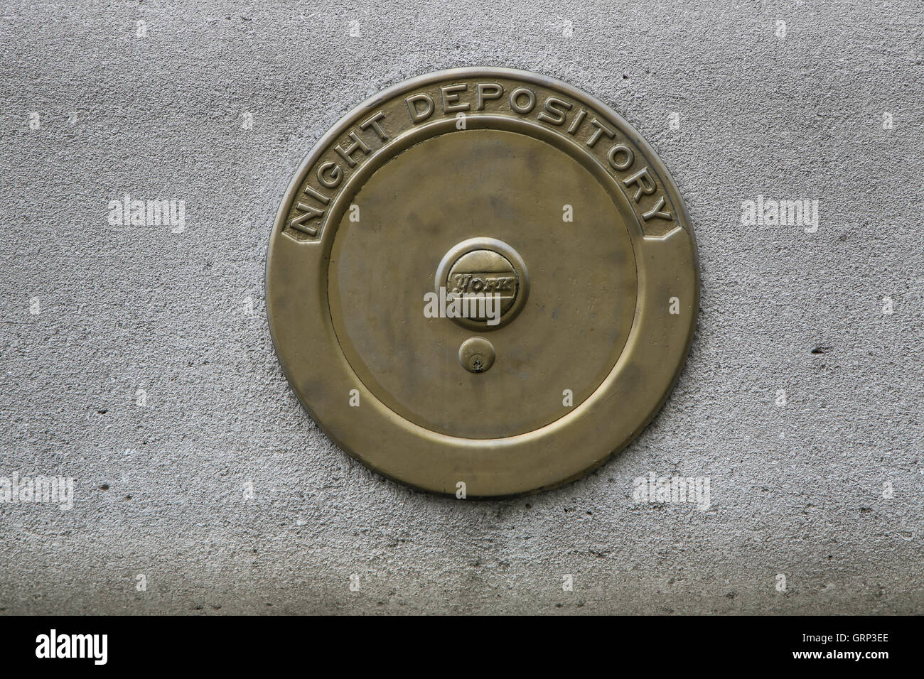 An old bank night depository cover in a building's wall in Manhattan. Stock Photo