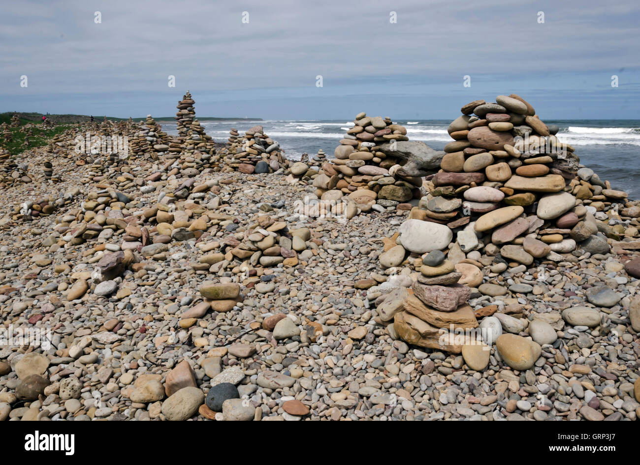 Pebbles piled up on a beach at Lindisfarne (Holy) Island in Northumberland, England. Stock Photo
