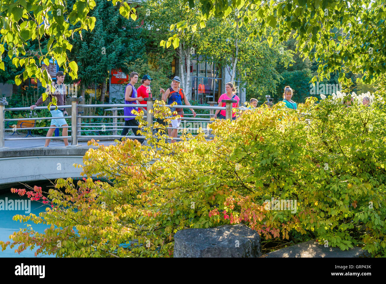 Tourists on Village Park pedestrian bridge, Whistler Village, Whistler