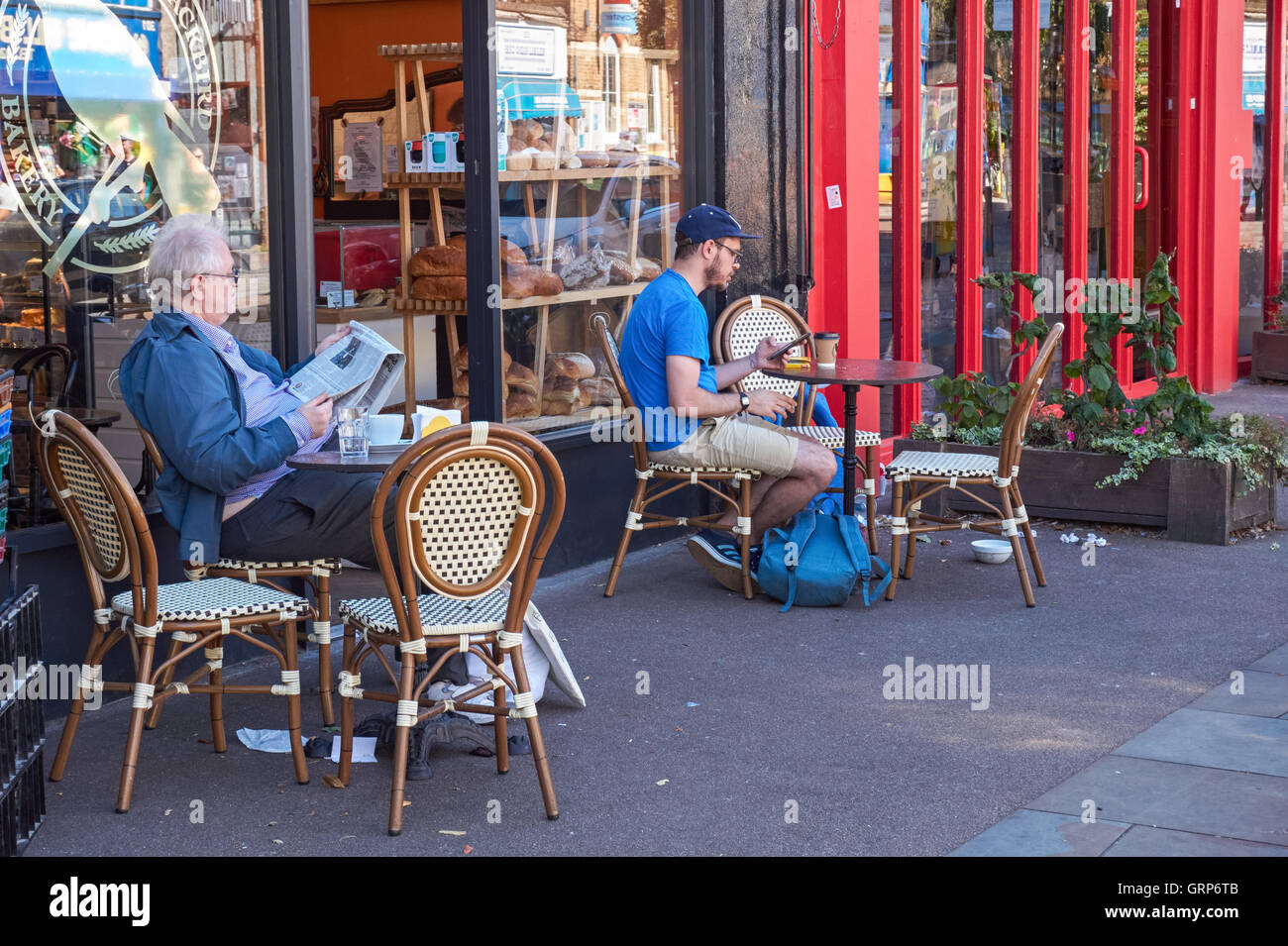 People sitting outside cafe in Herne Hill, London England United Kingdom UK Stock Photo