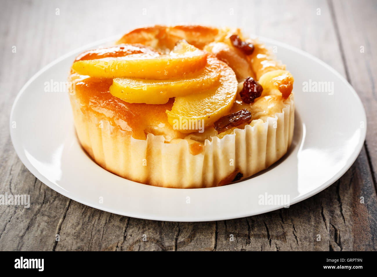homemade mini apple cake with caramelized apple wedges and raisins. Stock Photo