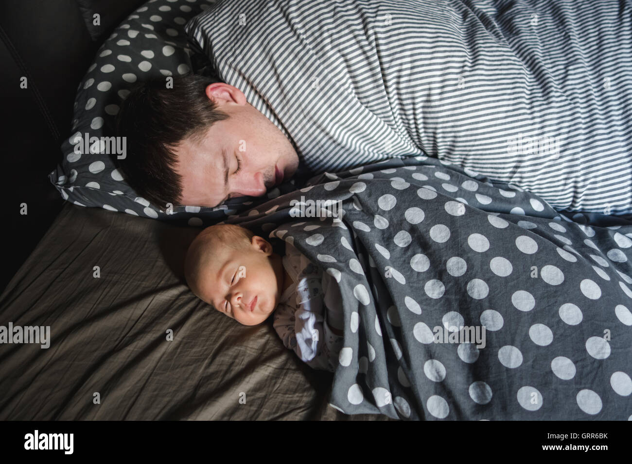 Newborn Baby boy sleep with his father Stock Photo