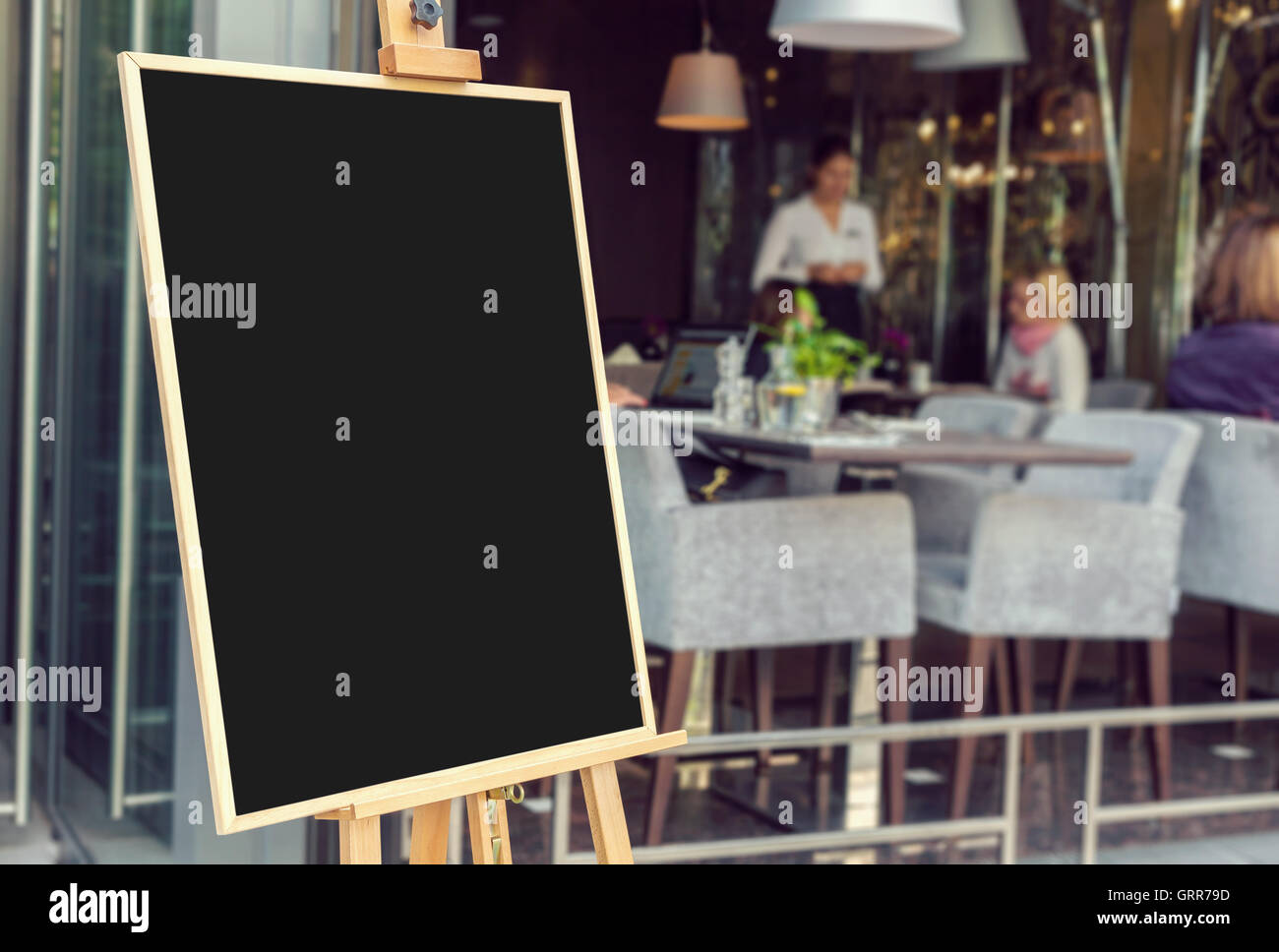 Blank restaurant menu blackboard with blurry people inside Stock Photo