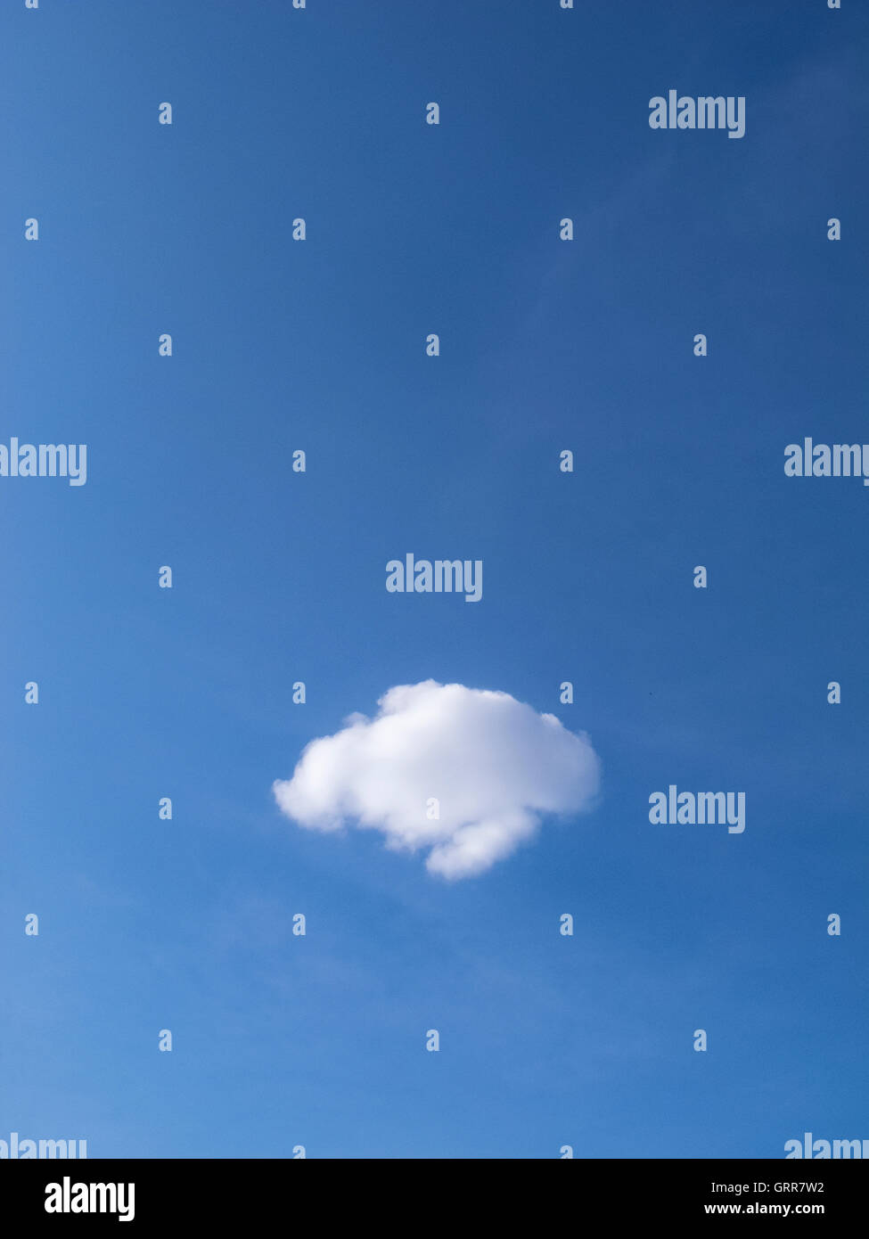 A lone perfect cloud in a blue sky Stock Photo