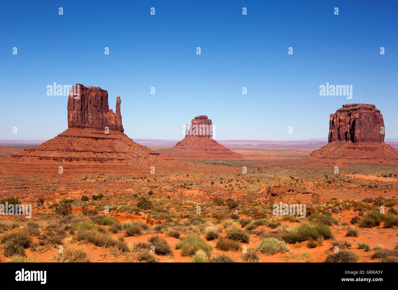 Three sandstone buttes in Monument Valley, Utah is part of the Navajo Tribal Park Reservation and is frequently used as a movie Stock Photo