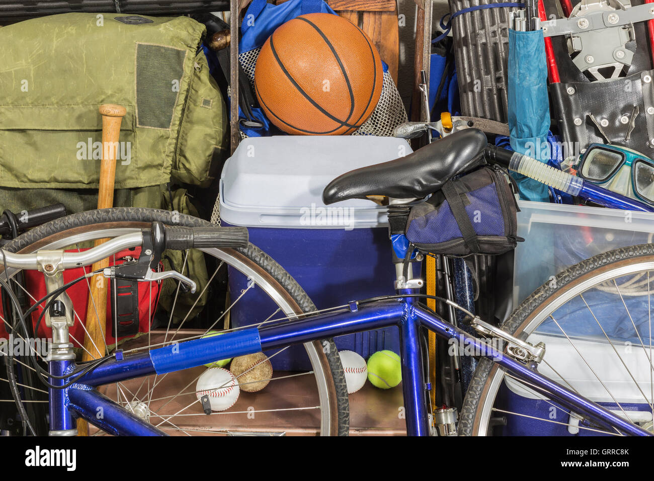 Vintage pile of worn sports and camping equipment.  Object names and logos were covered or removed. Stock Photo