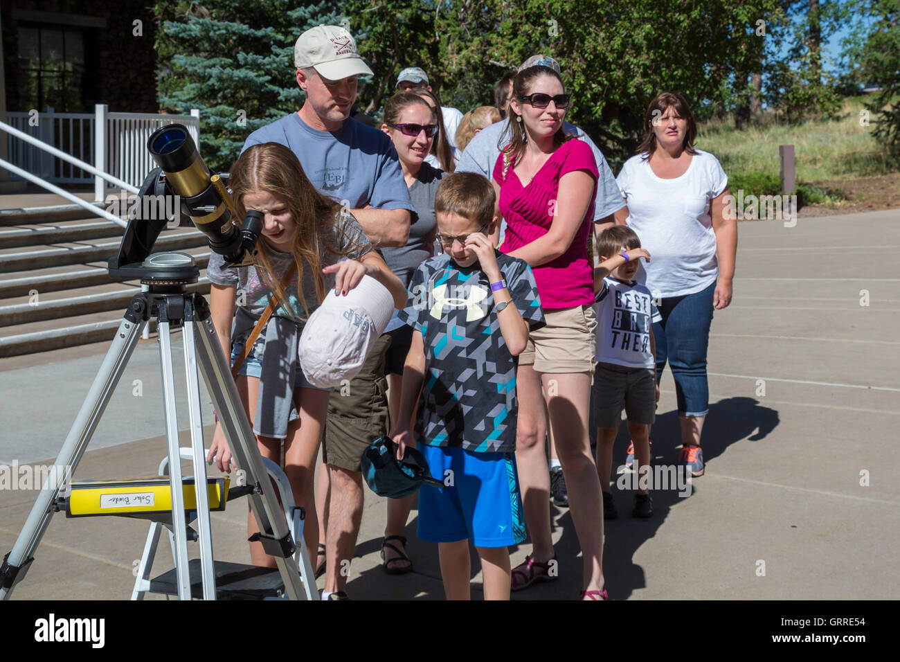 Flagstaff, Arizona - Visitors line up to look at the sun through a small telescope at the Lowell Observatory. Stock Photo