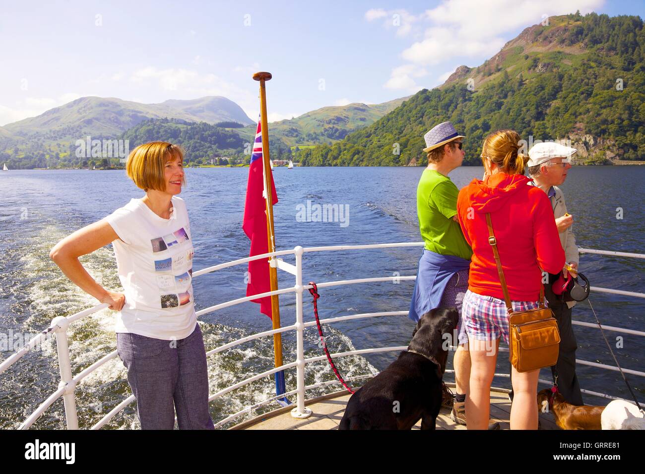 Tourists with their dogs enjoying a cruise aboard the stern of Ullswater Steamers. Ullswater, Penrith, The Lake District, UK. Stock Photo