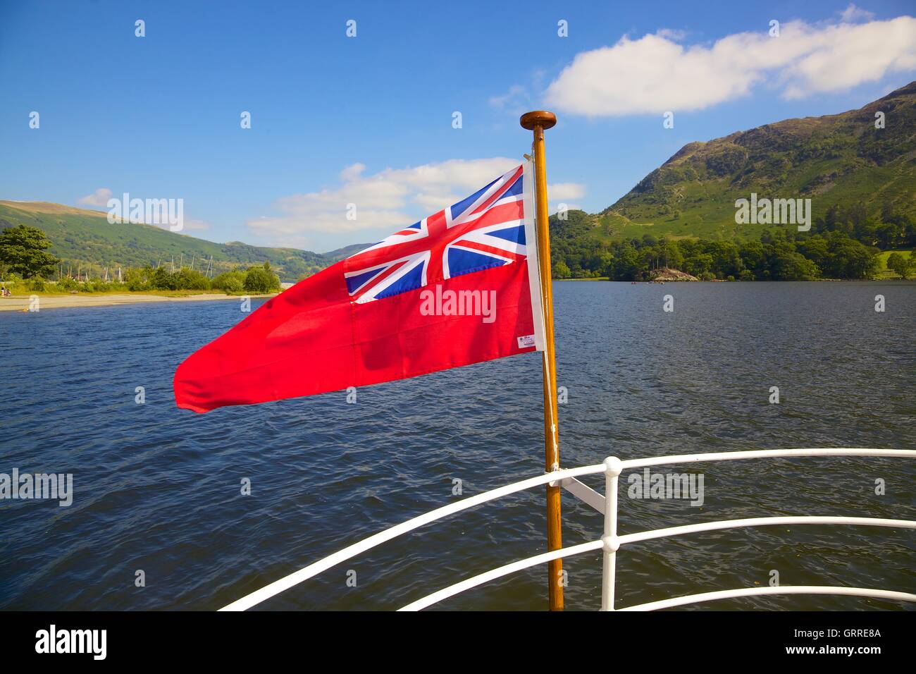 Red Ensign flag on the stern of Ullswater Steamers. Ullswater, Penrith, The Lake District National Park, Cumbria, England, UK. Stock Photo