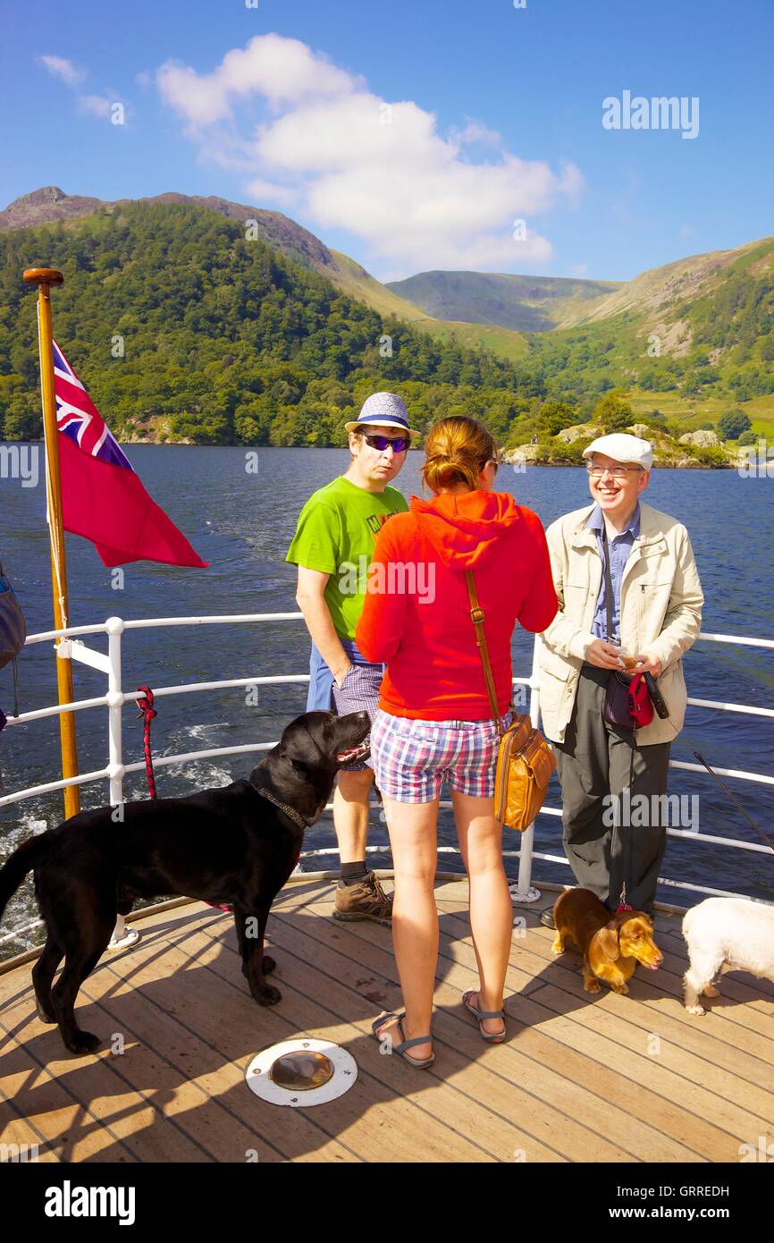 Tourists with their dogs enjoying a cruise aboard the stern of Ullswater Steamers  M.V Western Belle. Ullswater, Penrith, UK. Stock Photo