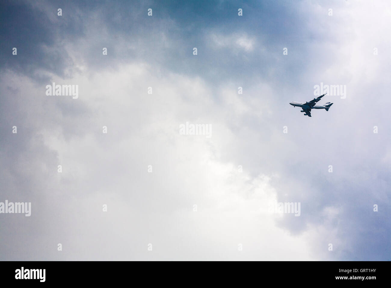 Passenger plane approaching against a stormy sky Stock Photo