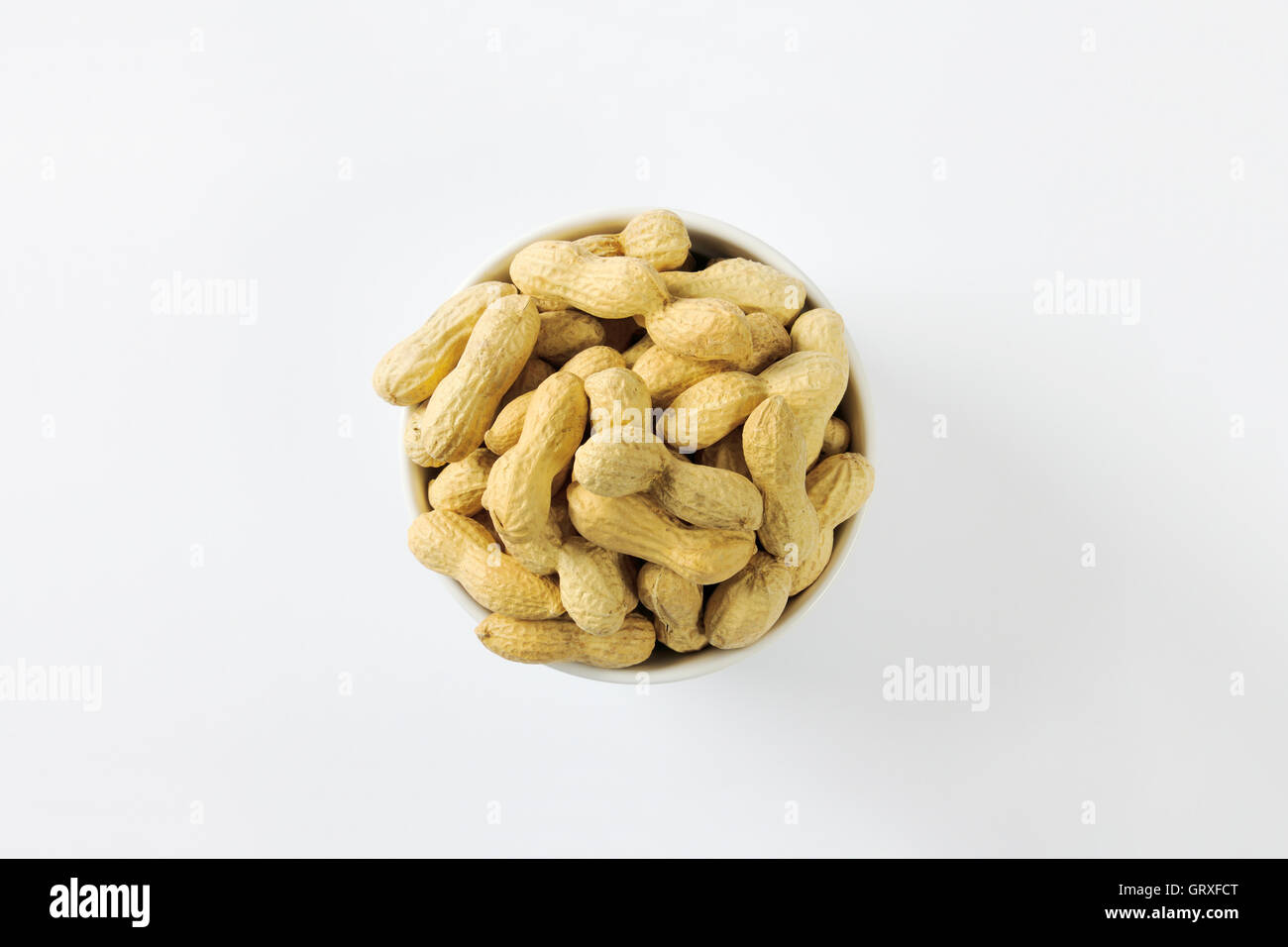 Bowl of raw unshelled peanuts Stock Photo