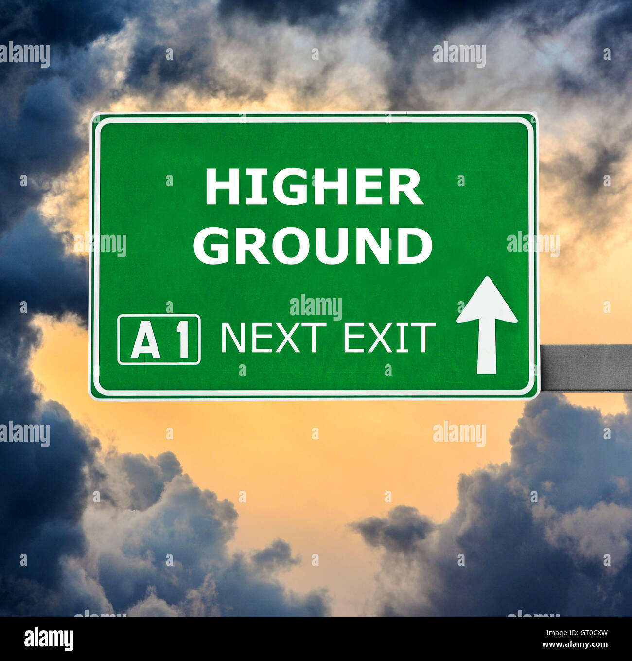 HIGHER GROUND road sign against clear blue sky Stock Photo