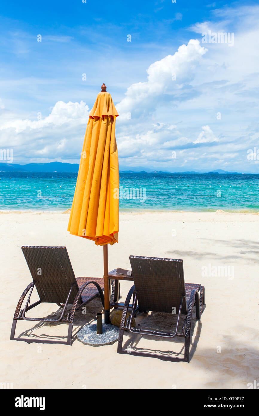 Two lounge chairs with sun umbrella on a beach Stock Photo