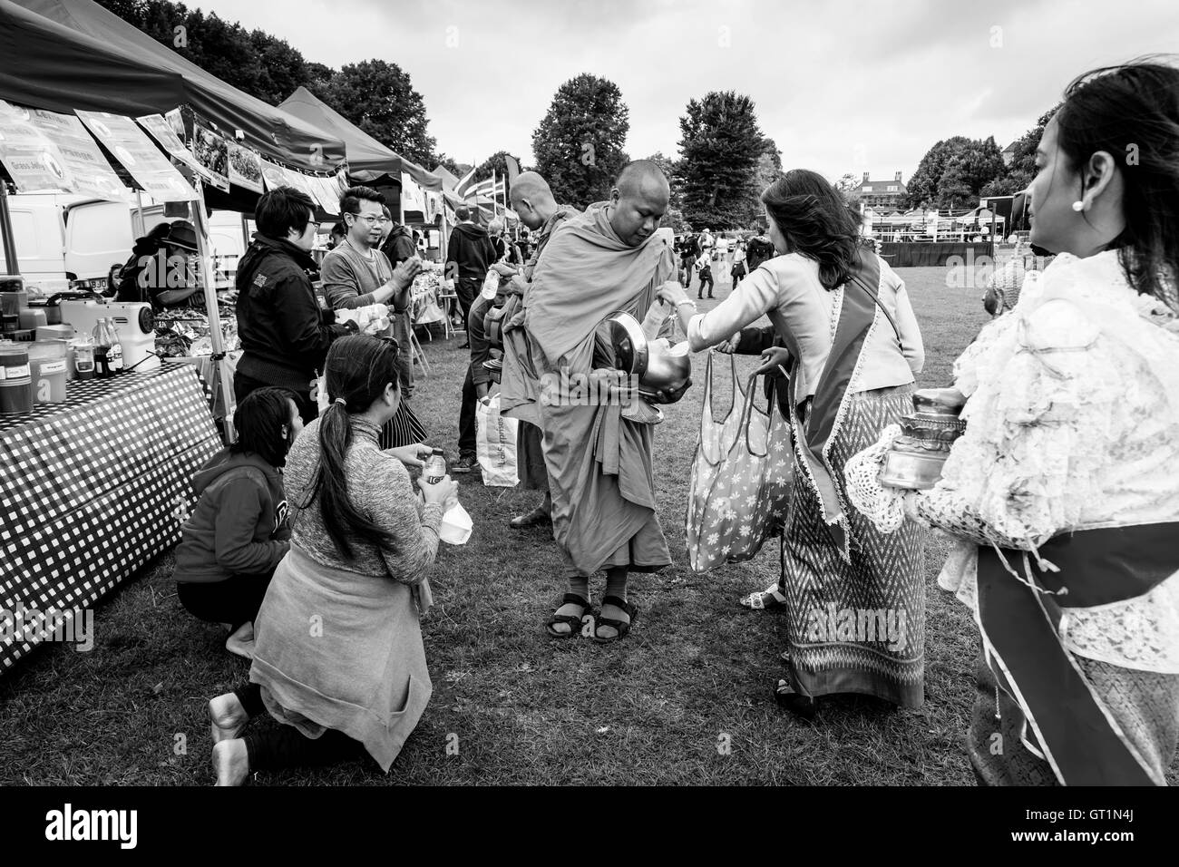 Thai People Offer Food To Two Monks At The Brighton Thai Festival