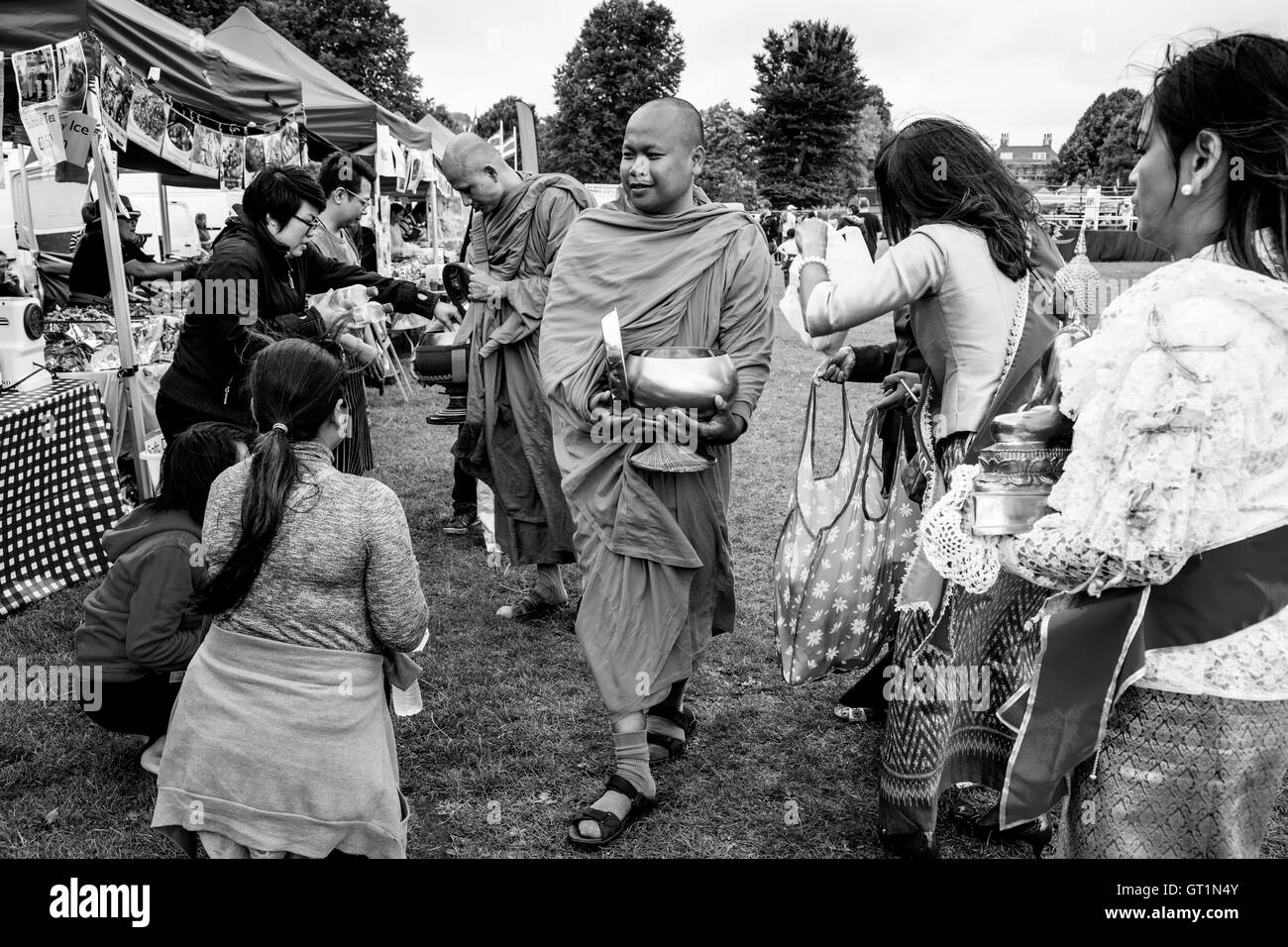 Thai People Offer Food To Two Monks At The Brighton Thai Festival