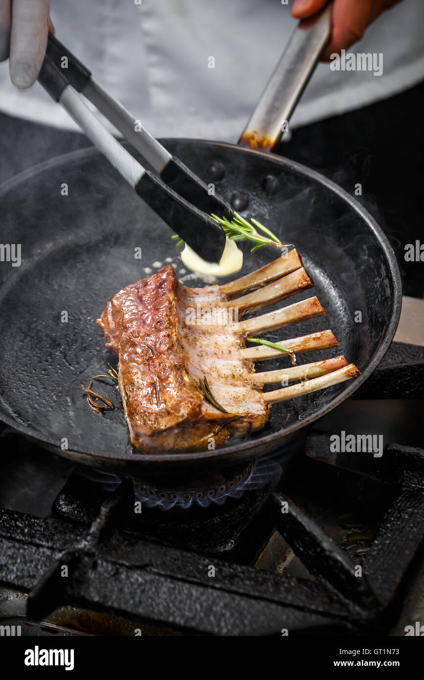 Racks of roasted lamb ribs with butter and rosemary Stock Photo Alamy
