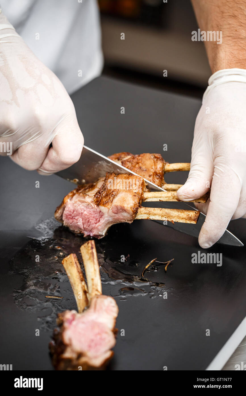 Chef sliced rack of lamb fried in aromatic olive oil, herbs and spices Stock Photo