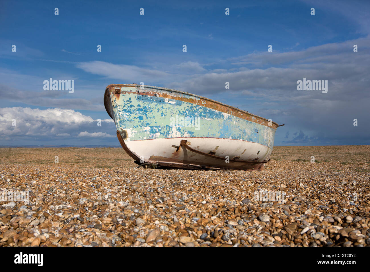 A derelict fishing boat on a shingle beach Stock Photo - Alamy