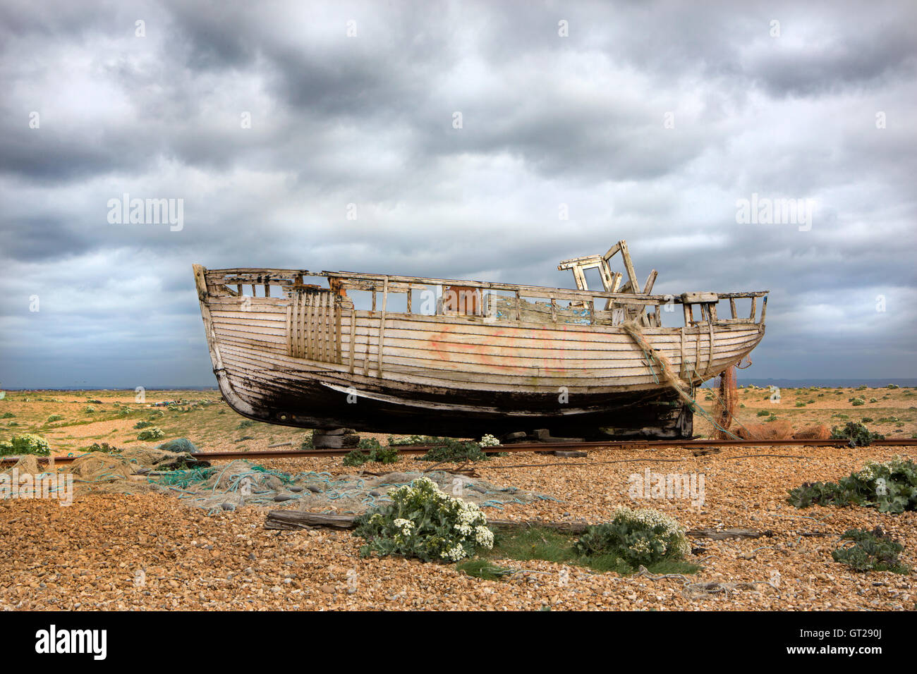 A derelict wooden fishing boat on a shingle beach Stock Photo - Alamy
