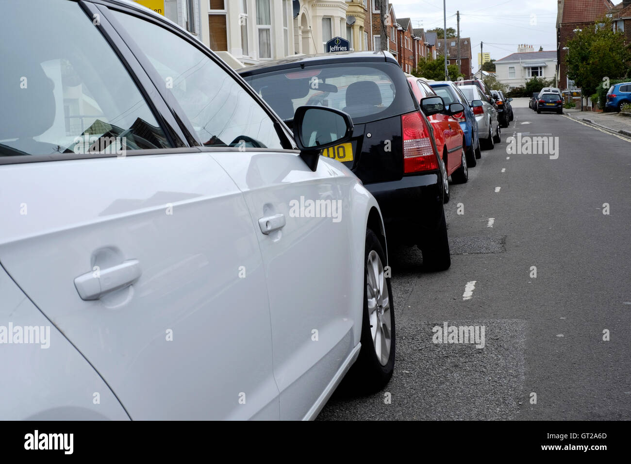 poorly parked car in a residential urban street england uk Stock Photo