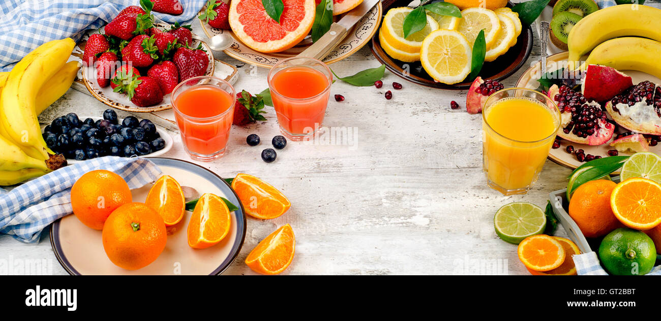 Healthy eating background. Different fruits and berries on white wooden table. Top view Stock Photo