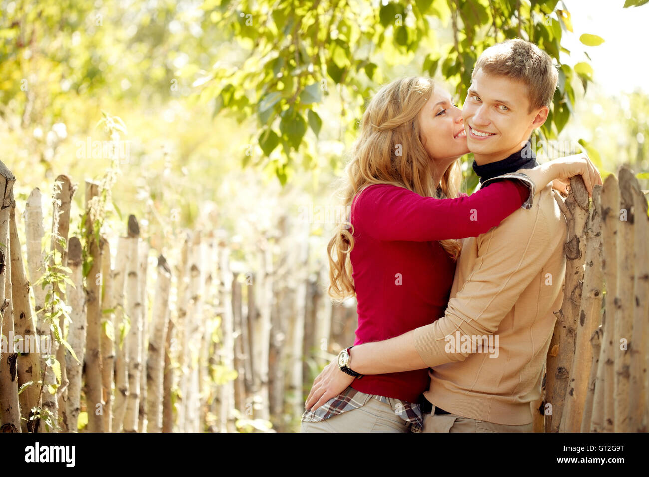 Couple by fence Stock Photo