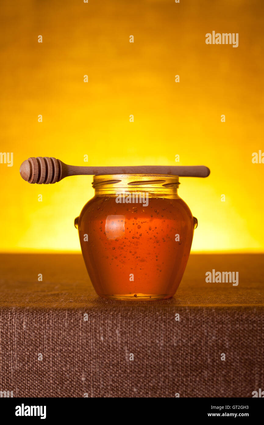 Honey jar with dipper Stock Photo Alamy