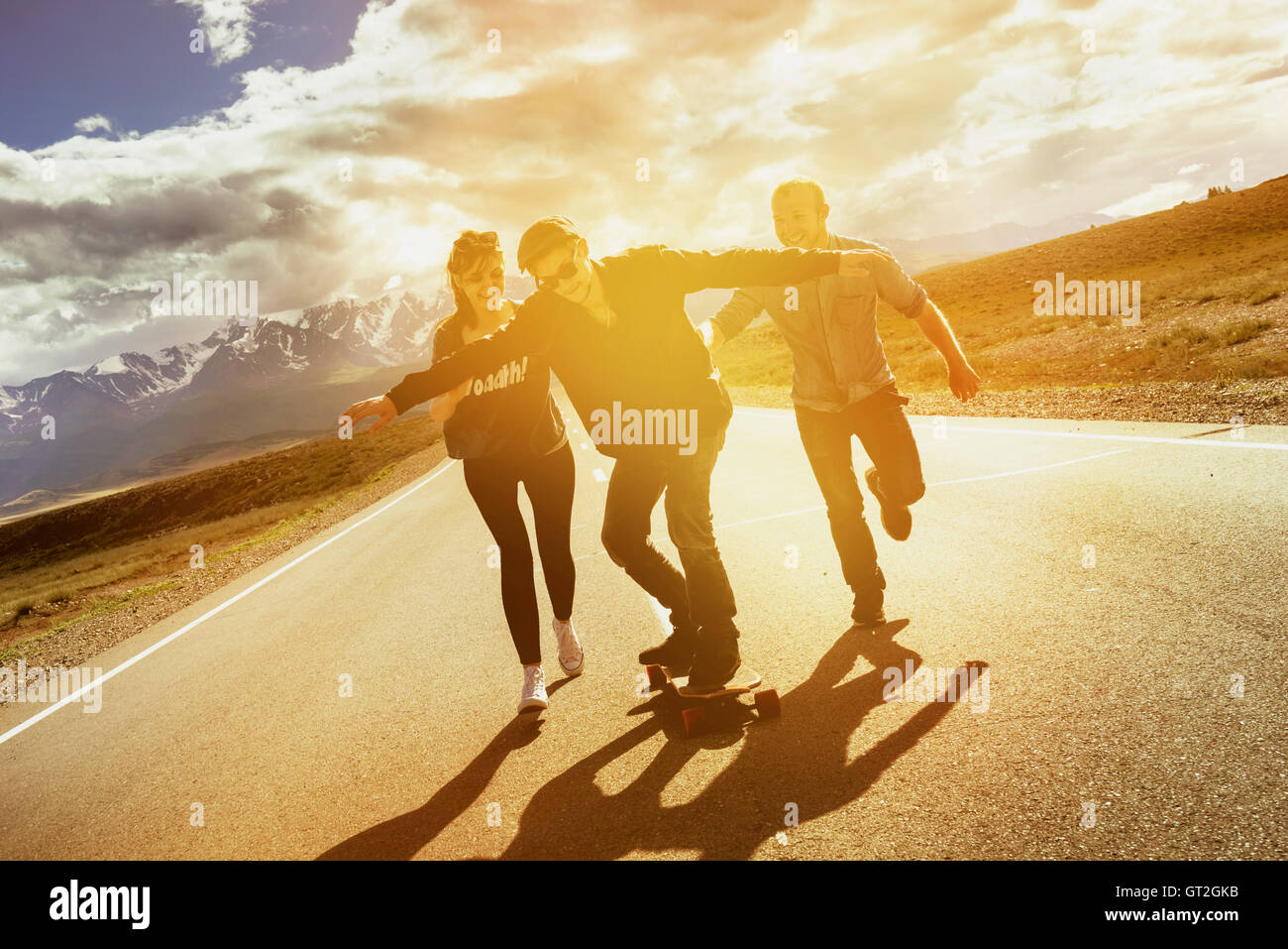 Group friends longboarding road travel concept Stock Photo