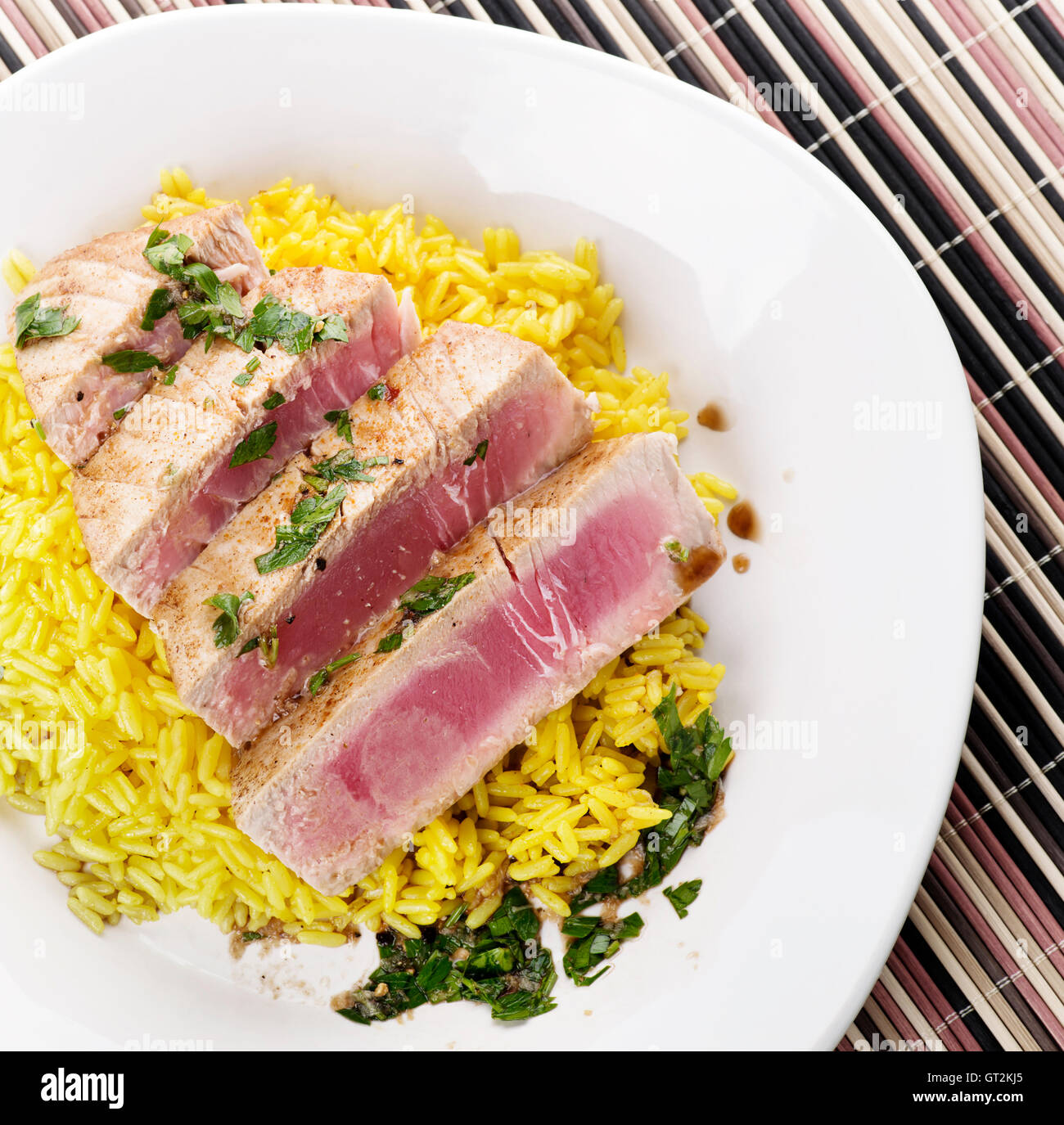 Ahi Tuna Steak With Rice and herbs sauce Stock Photo