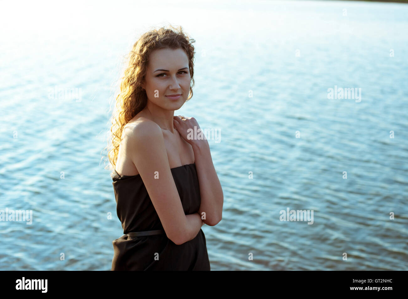Beautiful girl walks on the banks of river Stock Photo - Alamy
