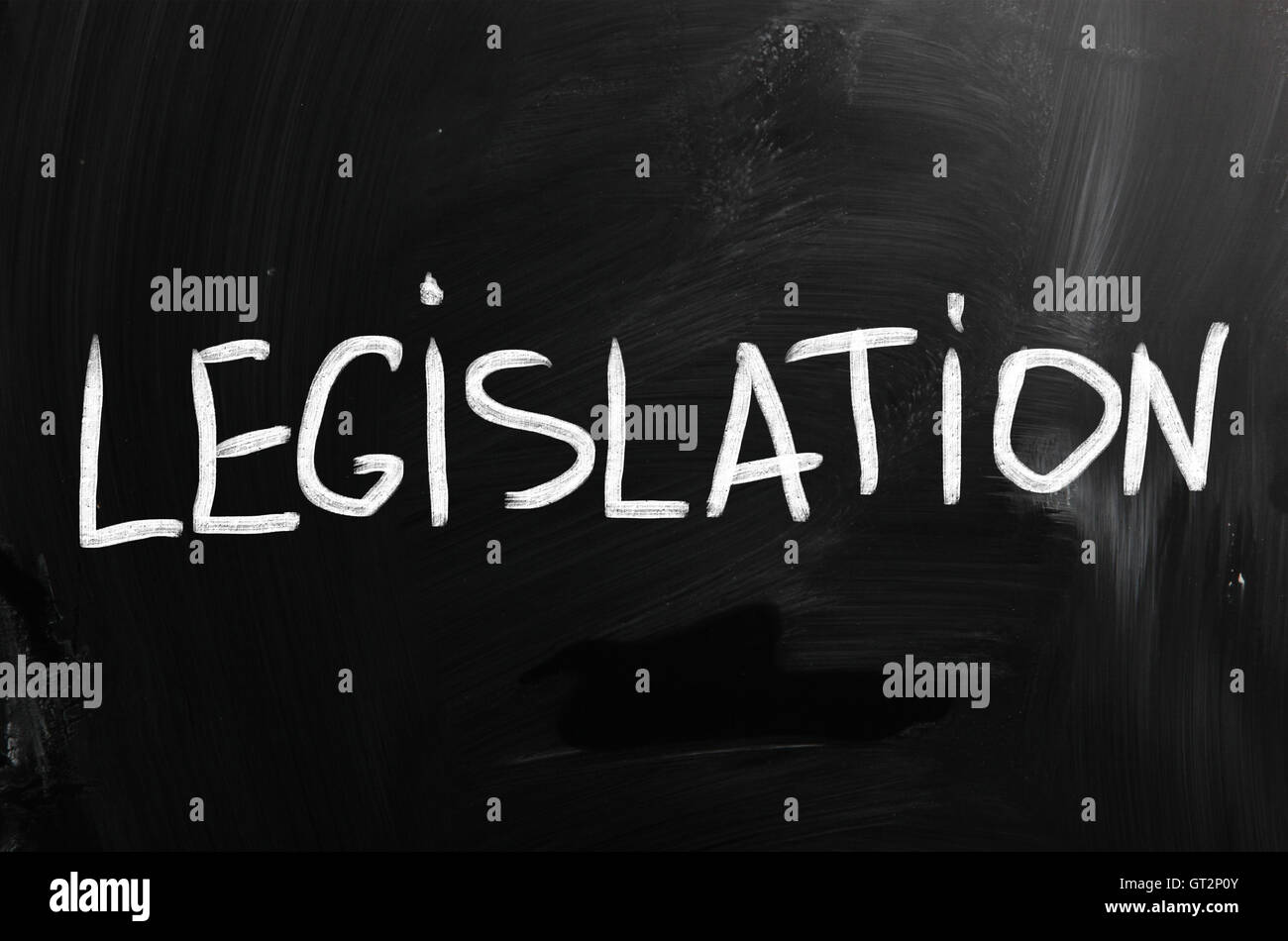 Legislation handwritten with white chalk on a blackboard Stock Photo