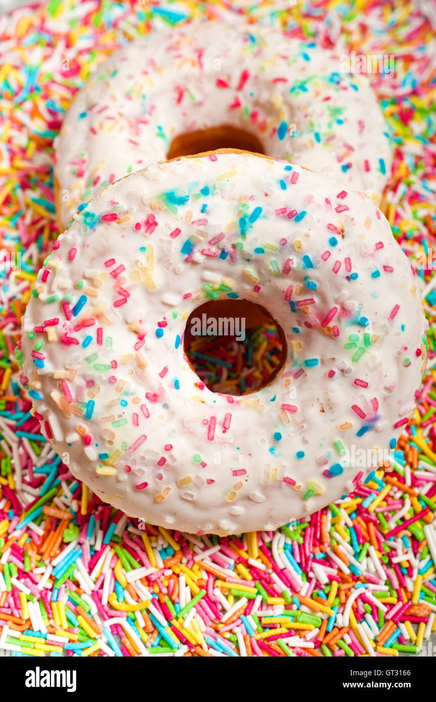 glazed donuts with colorful sprinkles Stock Photo Alamy