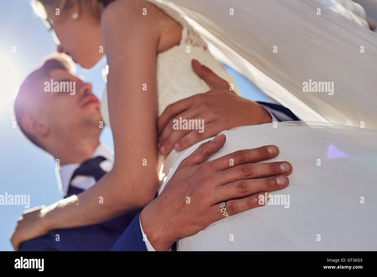 Close up hands of bride groom embracing Stock Photo