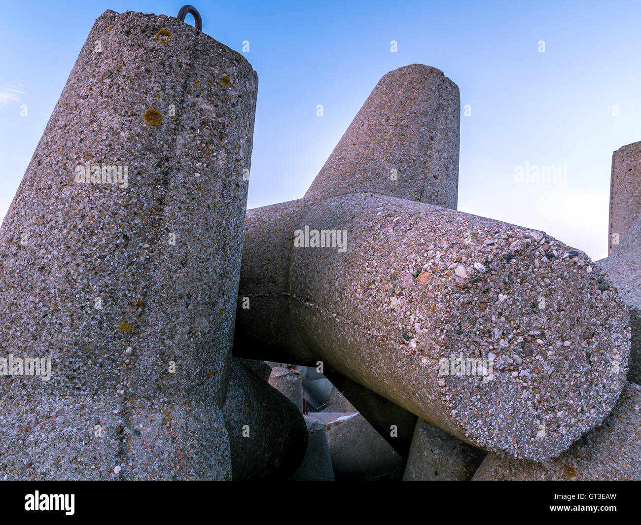 Massive concrete breakers stacked on the coastline Stock Photo