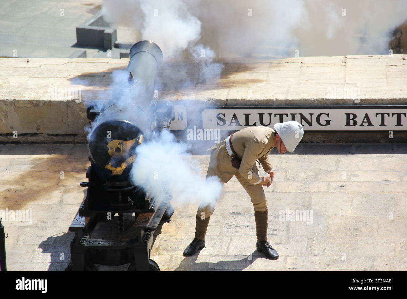 Guard firing the cannons in Saluting Battery (Valletta) Malta Stock
