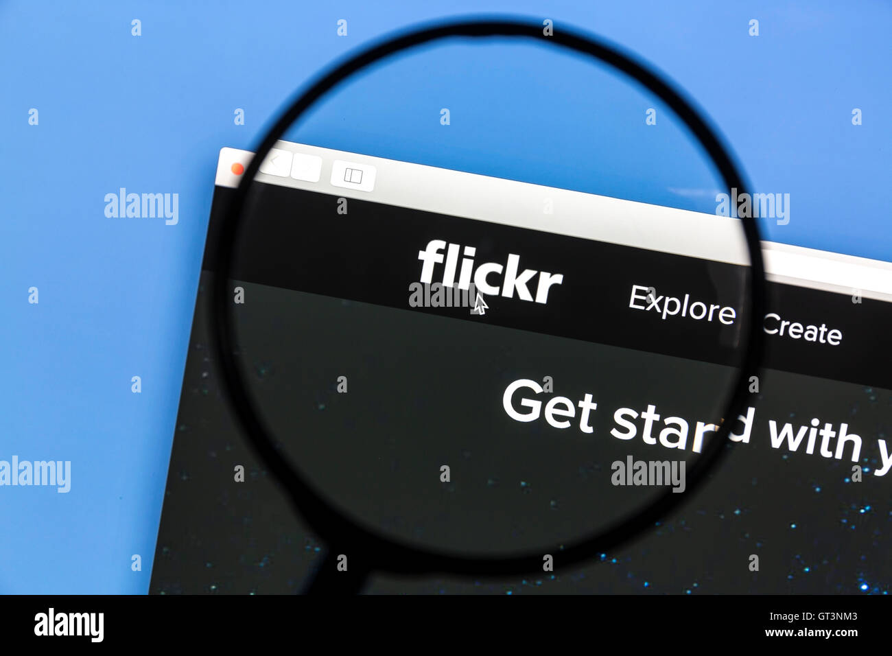 flickr website under a magnifying glass. Flickr is an image hosting and video hosting website and web services Stock Photo