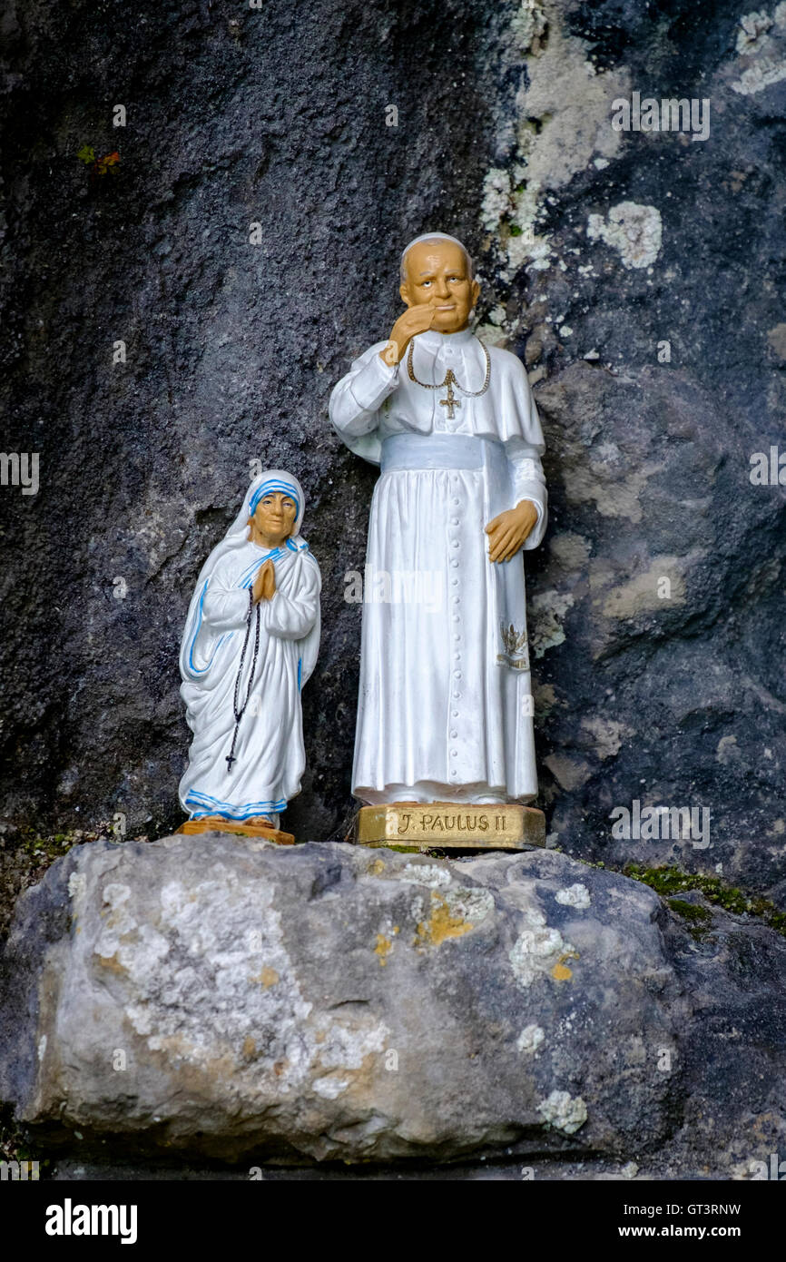 Models of Mother Teresa and Pope John Paul in a religious grotto France Stock Photo