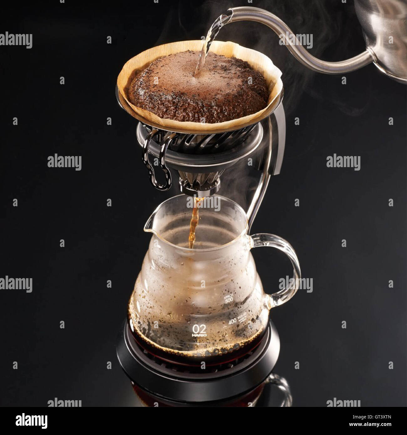Brewing coffee with black background, close up Stock Photo