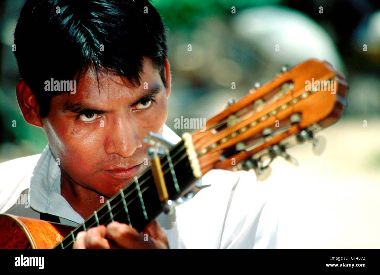 A mariachi sings while playing guitar