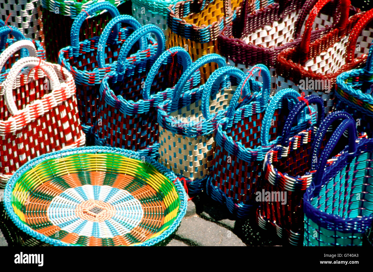 Stacks of colorful handmade woven baskets on display at a Mexican