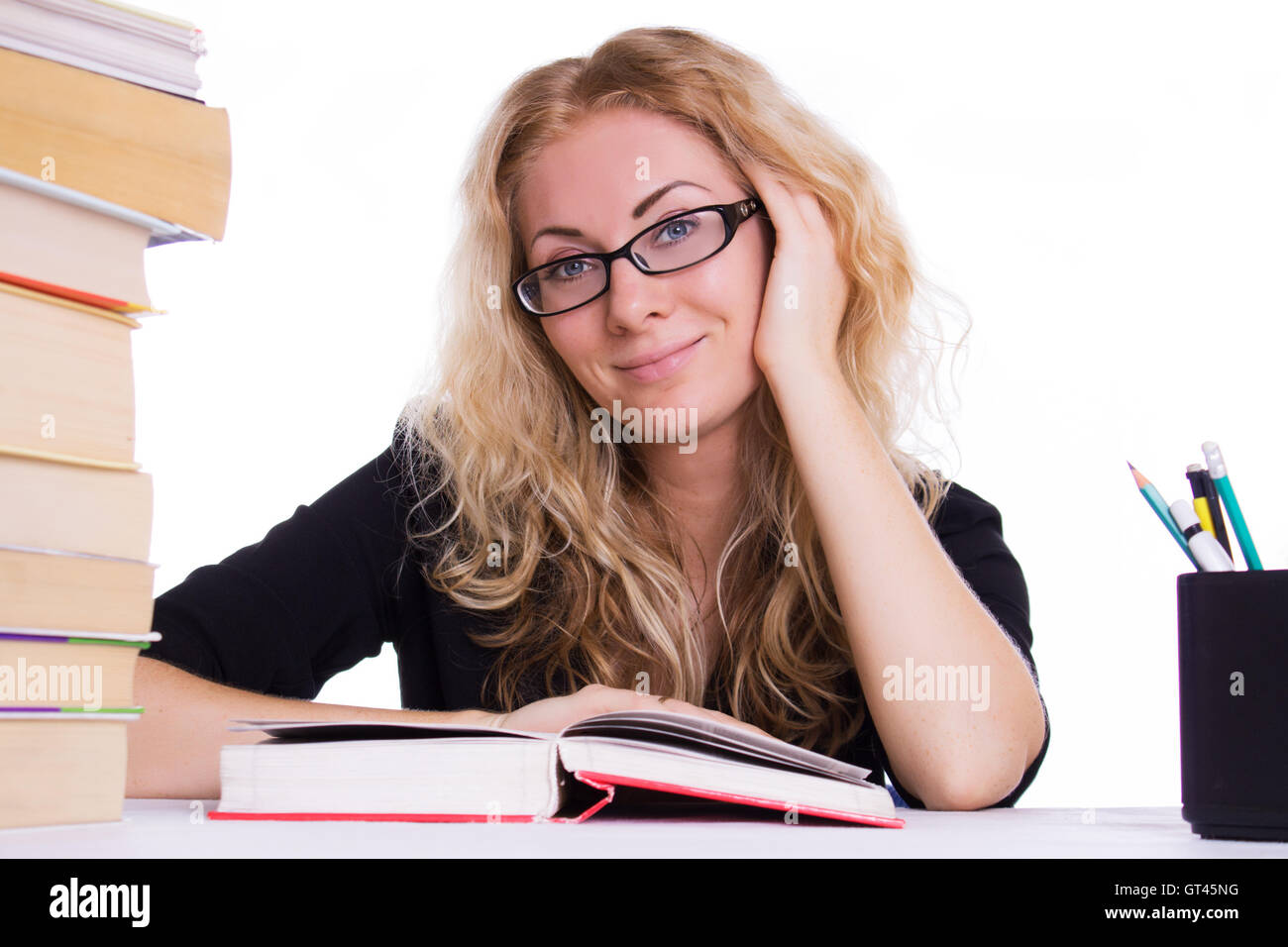 Smiling student girl with pile of books Stock Photo - Alamy