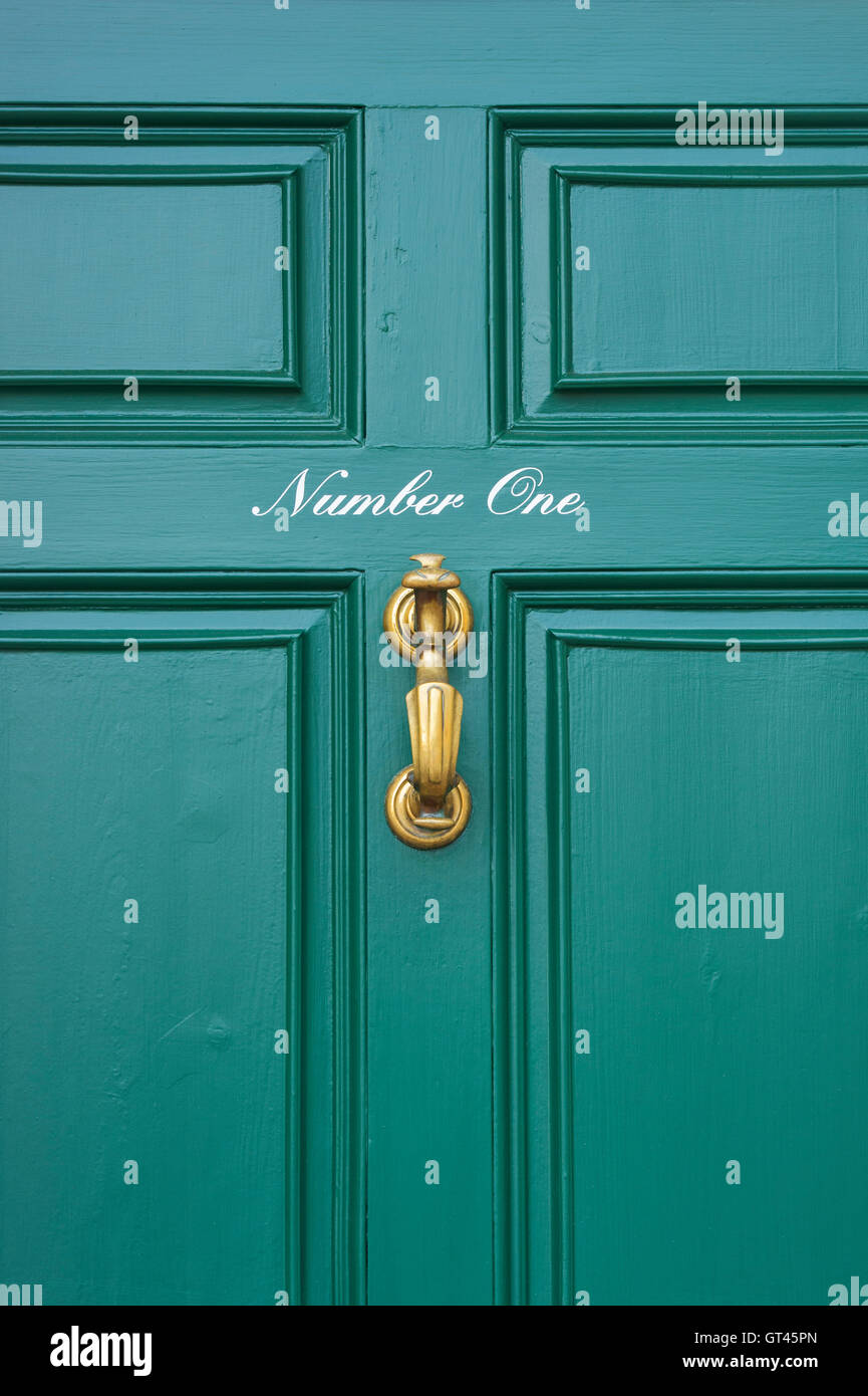 Number One written on a green / teal painted front house door. UK Stock Photo
