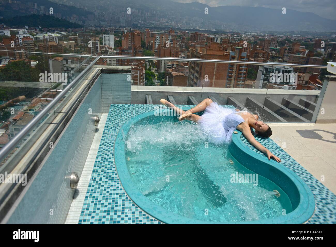 Ballerina in a rooftop jacuzzi in Medellin. Stock Photo