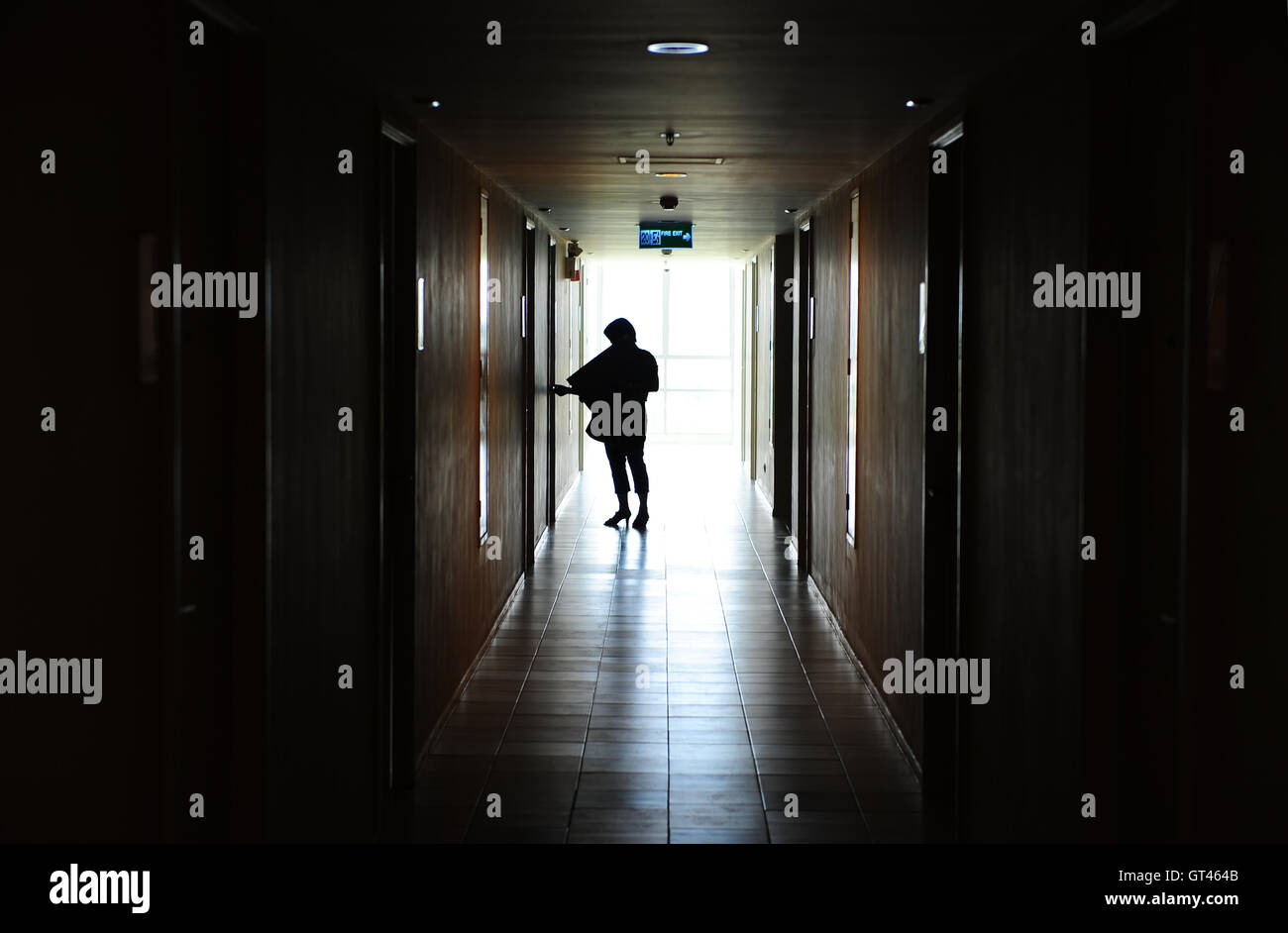 Woman opening door Stock Photo - Alamy